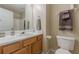 Bathroom featuring a vanity, commode, storage and decorative accessories at 71 Farm St, Hiram, GA 30141