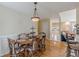 Bright dining area with hardwood floors, wainscoting, and a view into the entryway at 71 Farm St, Hiram, GA 30141