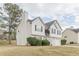 Charming two-story home featuring white siding, black shutters, and a well-manicured front yard at 71 Farm St, Hiram, GA 30141