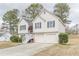 Two-story home with a brick-accented entrance, two-car garage, and a neatly paved driveway at 71 Farm St, Hiram, GA 30141