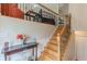Beautiful staircase with wooden treads and wrought iron railing near foyer with console table and flowers at 71 Farm St, Hiram, GA 30141