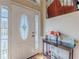 Bright and inviting foyer with decorative glass door and a quaint table with floral decorations at 71 Farm St, Hiram, GA 30141
