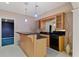 Basement bar area with pendant lighting, granite countertops, and modern appliances at 727 Vinings Estates Se Dr, Mableton, GA 30126