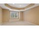 Bright bonus room showcasing a tray ceiling, window seat and neutral carpeting at 727 Vinings Estates Se Dr, Mableton, GA 30126