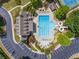 Aerial view of the community pool featuring a water slide and ample lounge seating at 727 Vinings Estates Se Dr, Mableton, GA 30126