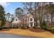 Beautiful brick home with black shutters, manicured lawn, and mature trees creating a serene and inviting curb appeal at 727 Vinings Estates Se Dr, Mableton, GA 30126