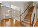 Bright foyer with hardwood floors, staircase and a view into the adjacent living spaces at 727 Vinings Estates Se Dr, Mableton, GA 30126