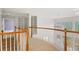 Upper hallway with bookshelves and view to outdoors at 727 Vinings Estates Se Dr, Mableton, GA 30126