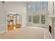 Bright and airy living room with high ceilings, fireplace and seamless transition to the kitchen area at 727 Vinings Estates Se Dr, Mableton, GA 30126