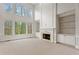 Open living room with fireplace, built-in shelving and soaring windows providing ample natural light at 727 Vinings Estates Se Dr, Mableton, GA 30126