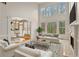 Bright living room with tall windows, fireplace, and open access to the kitchen area at 727 Vinings Estates Se Dr, Mableton, GA 30126