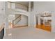 Bright living room with fireplace, staircase, and hardwood floors leading into a modern kitchen at 727 Vinings Estates Se Dr, Mableton, GA 30126