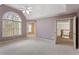 Spacious main bedroom with high ceiling, arched window, and adjoining rooms at 727 Vinings Estates Se Dr, Mableton, GA 30126
