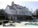 Beautiful two-story community clubhouse and pool with lounge chairs on a sunny day at 727 Vinings Estates Se Dr, Mableton, GA 30126