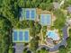 Aerial view of the community's well-maintained tennis courts surrounded by lush trees at 727 Vinings Estates Se Dr, Mableton, GA 30126
