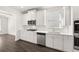 Bright kitchen boasts white cabinets, stainless appliances, and a subway tile backsplash at 13224 Tolstoy, Covington, GA 30014