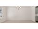 Spacious living room with carpet floors and a modern chandelier at 13224 Tolstoy, Covington, GA 30014