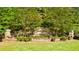 Stone community sign for Wildwood surrounded by greenery and landscaping at 13224 Tolstoy, Covington, GA 30014