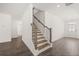 Elegant staircase with hardwood steps, iron spindles and white trim at 13224 Tolstoy, Covington, GA 30014