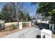 Gated driveway entrance to a beautiful home, featuring manicured landscaping and mature trees at 139 W Paces Ferry Nw Rd, Atlanta, GA 30305