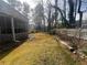 Side yard of a home featuring a mature, grassy lawn with a white picket fence at 2111 Kinridge Trl, Marietta, GA 30062