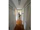 Hallway featuring hardwood floors, neutral walls, and plentiful storage with bi-fold door access at 2111 Kinridge Trl, Marietta, GA 30062