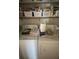 Laundry area featuring a standard top-load washer and electric dryer on upper shelving at 2111 Kinridge Trl, Marietta, GA 30062