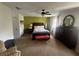 Comfortable main bedroom with a ceiling fan, natural light, and an accent wall creating a warm and inviting atmosphere at 2111 Kinridge Trl, Marietta, GA 30062