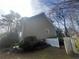 Side yard view of a home featuring neutral siding and white picket fence detail at 2111 Kinridge Trl, Marietta, GA 30062