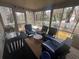 Comfortable sunroom featuring cozy seating, screened windows, and peaceful views of the outdoor landscape at 2111 Kinridge Trl, Marietta, GA 30062