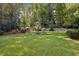 Expansive lawn with mature trees and manicured landscaping, perfect for outdoor activities and relaxation at 3814 Vermont Ne Rd, Atlanta, GA 30319