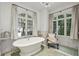 Stylish bathroom with a freestanding tub, large windows, and chic decor at 3814 Vermont Ne Rd, Atlanta, GA 30319
