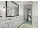 Elegant bathroom with marble countertop, dual sinks, and a separate glass-enclosed shower with green tile flooring at 3814 Vermont Ne Rd, Atlanta, GA 30319