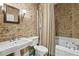 Cozy bathroom featuring a vintage map wallpaper, complemented by chrome fixtures and a shower-tub combination at 3814 Vermont Ne Rd, Atlanta, GA 30319