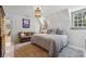 Charming bedroom featuring a decorative chandelier, a sitting area, and an inviting window at 3814 Vermont Ne Rd, Atlanta, GA 30319