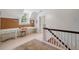 Versatile bonus room features white floors, a long desk and a cozy rug at the base of the stairs at 3814 Vermont Ne Rd, Atlanta, GA 30319