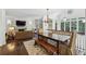 Sun-filled dining area with large windows, hardwood floors, and views of the backyard at 3814 Vermont Ne Rd, Atlanta, GA 30319