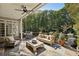 Inviting outdoor patio with comfortable seating, a ceiling fan, and a view of the wooded backyard at 3814 Vermont Ne Rd, Atlanta, GA 30319