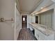 Bright bathroom featuring double sink vanity, granite countertops and hardwood style floors at 4614 Blakedale Cir, Roswell, GA 30075