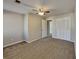 This bedroom offers neutral walls and carpet and a modern ceiling fan with lights at 4614 Blakedale Cir, Roswell, GA 30075