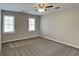 Bright and airy bedroom with carpet, neutral walls, and a ceiling fan at 4614 Blakedale Cir, Roswell, GA 30075