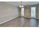 Dining room with wood floors, wainscotting, a chandelier and plenty of natural light at 4614 Blakedale Cir, Roswell, GA 30075
