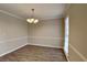 Bright dining room featuring wood floors, a chandelier, and neutral walls at 4614 Blakedale Cir, Roswell, GA 30075