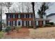Charming two-story brick home with black shutters and a well-manicured lawn at 4614 Blakedale Cir, Roswell, GA 30075