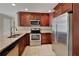 A well-lit kitchen featuring stainless steel appliances, dark cabinetry and granite countertops at 4614 Blakedale Cir, Roswell, GA 30075