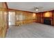 Large open living room with fireplace, built in shelves, and hardwood-style paneling at 4614 Blakedale Cir, Roswell, GA 30075