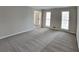 Neutral living room featuring neutral-colored walls, carpeted floors, and a large window at 4614 Blakedale Cir, Roswell, GA 30075