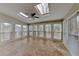 Bright sunroom featuring multiple windows, skylights, ceiling fan, and tile flooring, perfect for relaxation and natural light at 4614 Blakedale Cir, Roswell, GA 30075