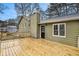 Expansive new wooden deck adds outdoor living space to this charming home with a lovely light green exterior at 832 Toonigh Rd, Canton, GA 30115