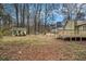 A large backyard provides ample space for outdoor activities with a storage building and partial fencing at 832 Toonigh Rd, Canton, GA 30115